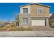 Charming two-story home featuring stone accents, a two-car garage, and landscaped front yard at 290 Mount Tyndall St, Henderson, NV 89015