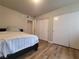 Bright bedroom with wood flooring, a comfortable bed, and mirrored closet doors at 3083 Casey Dr # 101, Las Vegas, NV 89120