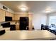 Charming kitchen featuring wood cabinets, an island bar, and a dining table with chairs at 3083 Casey Dr # 101, Las Vegas, NV 89120