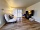 Sunlit living room featuring wood-look flooring, neutral walls, and a sliding glass door at 3083 Casey Dr # 101, Las Vegas, NV 89120