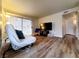Cozy living room featuring wood-look floors, neutral walls, and a view to the outside at 3083 Casey Dr # 101, Las Vegas, NV 89120