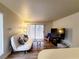 Cozy living room with a sofa, a rocking chair, and a sliding glass door to a balcony at 3083 Casey Dr # 101, Las Vegas, NV 89120