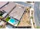 Aerial view of the house and surrounding desert-style landscaping with a pool and spa in the backyard at 314 Meadow Brush Pl, Henderson, NV 89011