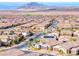 Aerial view of a neighborhood of homes set against the mountains and open skies at 314 Meadow Brush Pl, Henderson, NV 89011