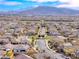 Aerial view of a neighborhood and the mountains in the distance, under a clear blue sky at 314 Meadow Brush Pl, Henderson, NV 89011