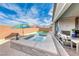 Backyard featuring a pool, spa, covered patio, and outdoor seating at 314 Meadow Brush Pl, Henderson, NV 89011