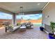 Covered patio with outdoor seating area overlooks a pool and spa at 314 Meadow Brush Pl, Henderson, NV 89011