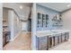 Stylish home bar featuring custom wine racks, shelving and a beverage cooler at 314 Meadow Brush Pl, Henderson, NV 89011