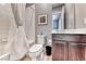 Bathroom with modern sink, vanity, toilet and shower with white curtain at 314 Meadow Brush Pl, Henderson, NV 89011
