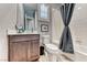 Bathroom with modern sink, vanity, toilet and shower with gray curtain at 314 Meadow Brush Pl, Henderson, NV 89011