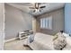 Cozy bedroom featuring a ceiling fan, neutral walls, and a white media center at 314 Meadow Brush Pl, Henderson, NV 89011