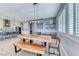 Open concept dining room with modern light fixture and bar next to the kitchen at 314 Meadow Brush Pl, Henderson, NV 89011