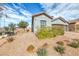 Charming front yard features desert landscaping with a bench next to the sidewalk at 314 Meadow Brush Pl, Henderson, NV 89011