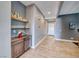 Hallway with light wood floors, gray walls, and floating shelves with decorations at 314 Meadow Brush Pl, Henderson, NV 89011
