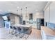 Open concept kitchen with a large island, stainless steel appliances, and a cozy fireplace at 314 Meadow Brush Pl, Henderson, NV 89011
