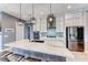 Spacious kitchen with island seating, modern appliances, and ample cabinet space at 314 Meadow Brush Pl, Henderson, NV 89011