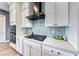 The kitchen features modern appliances, white cabinets, and a stylish tile backsplash at 314 Meadow Brush Pl, Henderson, NV 89011