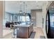 Gourmet kitchen flows to living area, showcasing large island, pendant lighting and outdoor views at 314 Meadow Brush Pl, Henderson, NV 89011