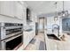 Modern kitchen with a sleek cooktop, stainless steel appliances, and white cabinetry at 314 Meadow Brush Pl, Henderson, NV 89011
