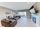 Bright living room with fireplace, modern furnishings, wood floors, and open access to the patio at 314 Meadow Brush Pl, Henderson, NV 89011