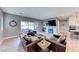 Spacious living room with modern furnishings, wood floors, fireplace, and open patio access at 314 Meadow Brush Pl, Henderson, NV 89011