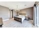 Comfortable main bedroom with rustic wood bed frame, neutral walls, and slider to outdoor living space at 314 Meadow Brush Pl, Henderson, NV 89011