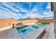 Beautiful backyard pool and spa feature an umbrella and plenty of room for entertaining at 314 Meadow Brush Pl, Henderson, NV 89011