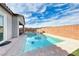 Backyard with a pool, spa, covered patio, and lush landscaping at 314 Meadow Brush Pl, Henderson, NV 89011
