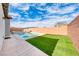 Backyard with a sparkling pool and spa area with green grass at 314 Meadow Brush Pl, Henderson, NV 89011