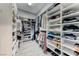 Walk-in closet with custom shelving and organized storage solutions for clothes and shoes at 314 Meadow Brush Pl, Henderson, NV 89011