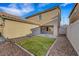 View of the backyard with a patch of grass and rock landscaping, offering a low-maintenance outdoor space at 3189 Sisley Garden Ave, Henderson, NV 89044