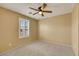 Bedroom featuring carpet, ceiling fan, window with plantation shutters at 3189 Sisley Garden Ave, Henderson, NV 89044