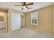 Cozy bedroom features a ceiling fan, neutral carpet, and a large closet for ample storage at 3189 Sisley Garden Ave, Henderson, NV 89044
