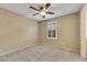 Bedroom with a ceiling fan, neutral carpet, and plantation shutters at 3189 Sisley Garden Ave, Henderson, NV 89044