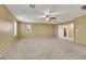 Neutral bedroom with carpet flooring and a door to the laundry room for convenience at 3189 Sisley Garden Ave, Henderson, NV 89044