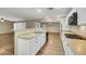 Open-concept kitchen with white cabinets, stainless steel appliances, and a breakfast bar offering ample counter space at 3189 Sisley Garden Ave, Henderson, NV 89044