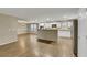 Spacious kitchen featuring white cabinets, stainless steel appliances, and an island bar with an open design to dining area at 3189 Sisley Garden Ave, Henderson, NV 89044