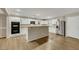 Well-lit kitchen features white cabinets, stainless steel appliances, and a large island bar perfect for entertaining guests at 3189 Sisley Garden Ave, Henderson, NV 89044