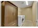 Laundry room with large storage cabinet, a folding rack and tile floors at 3189 Sisley Garden Ave, Henderson, NV 89044