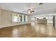Bright, open-concept living area flows into kitchen, featuring hardwood floors and large windows at 3189 Sisley Garden Ave, Henderson, NV 89044