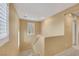 A carpeted staircase with freshly painted walls and natural light from adjacent windows at 3189 Sisley Garden Ave, Henderson, NV 89044