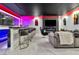 Finished basement bar area with neon lighting, modern barstools, and a TV at 3266 S Spring Mountain Blvd, Pahrump, NV 89048