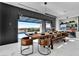 Bright dining room featuring a wooden table, leather chairs, a bench and sliding glass doors to an outdoor area at 3266 S Spring Mountain Blvd, Pahrump, NV 89048
