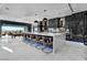 Modern kitchen with a large waterfall island, cowhide stools, and sliding doors to a pool and outdoor dining area at 3266 S Spring Mountain Blvd, Pahrump, NV 89048
