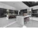 Modern kitchen with waterfall island, premium appliances, and sleek dark cabinetry at 3266 S Spring Mountain Blvd, Pahrump, NV 89048