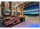 Modern living room with a fireplace, TV, custom desk and large glass window showcasing the pool at 3266 S Spring Mountain Blvd, Pahrump, NV 89048