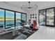 Modern living room with unique furniture, a decorative chandelier, and sliding doors to an outdoor area with a view at 3266 S Spring Mountain Blvd, Pahrump, NV 89048