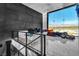 Modern living space with a decorative lighting fixture and a large window with views of the mountains at 3266 S Spring Mountain Blvd, Pahrump, NV 89048
