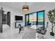 Bright home office with a modern desk, decorative plant, and a view of the surrounding mountains at 3266 S Spring Mountain Blvd, Pahrump, NV 89048
