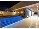 Stylish outdoor patio with a hot tub, blue-lit stairs, and a seamless indoor-outdoor transition at 3266 S Spring Mountain Blvd, Pahrump, NV 89048